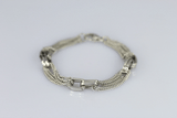 Stainless steel chain bracelet with rectangular fasteners used for embossed wear.
